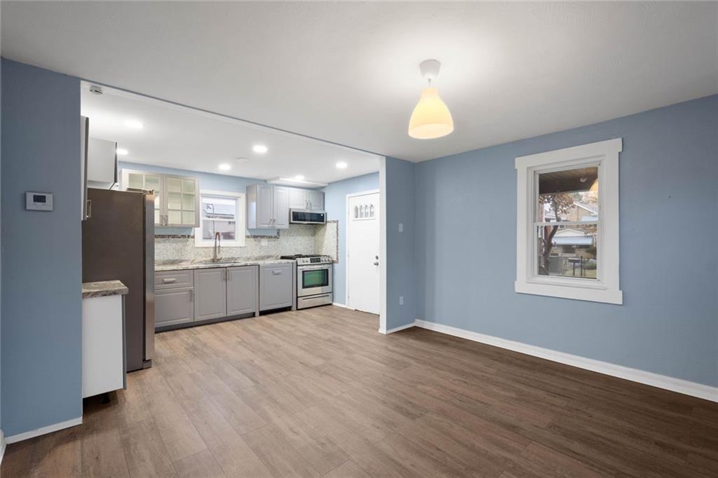 7129 Michigan Street Pittsburgh, PA 15218 - Photo 5 of 25 a view of kitchen with wooden floor and electronic appliances