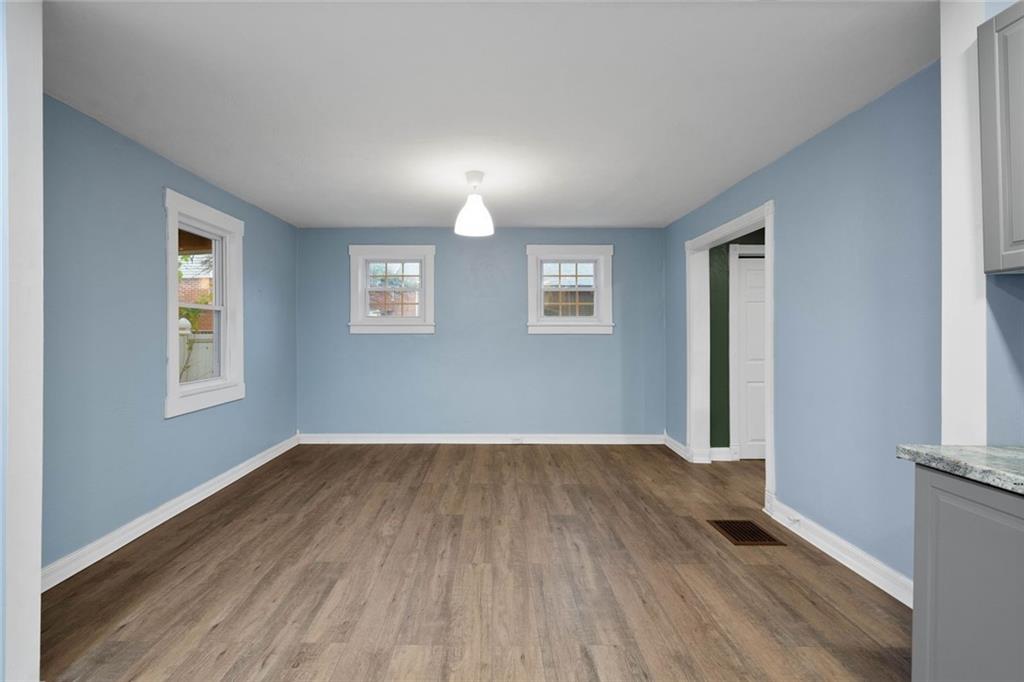 7129 Michigan Street Pittsburgh, PA 15218 - Photo 6 of 25 an empty room with wooden floor and windows