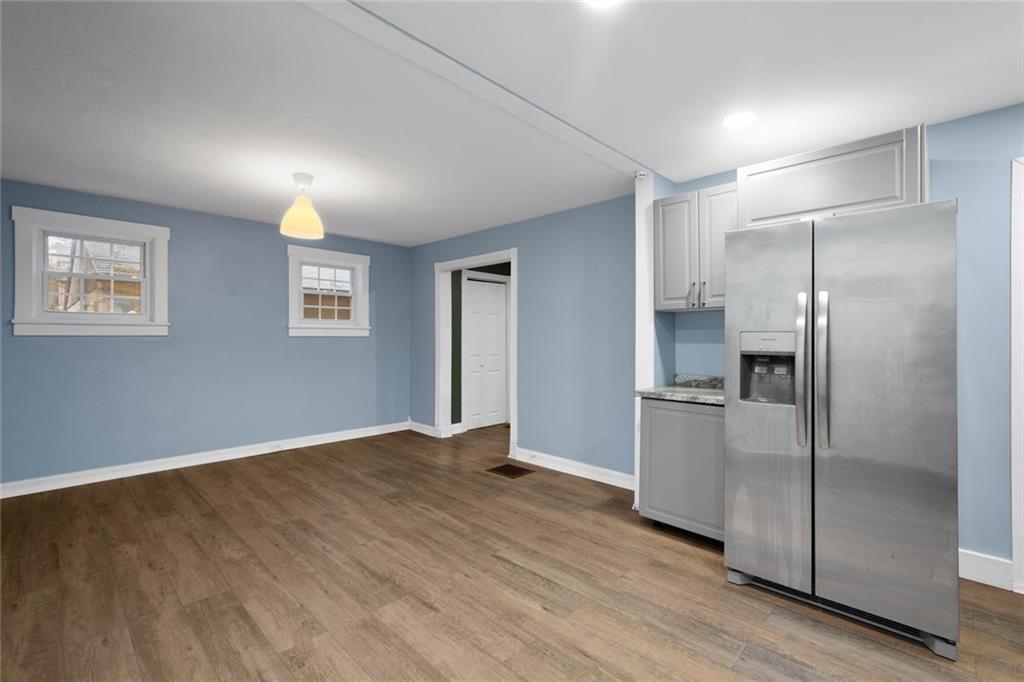 7129 Michigan Street Pittsburgh, PA 15218 - Photo 9 of 25 a view of an empty room with window and wooden floor