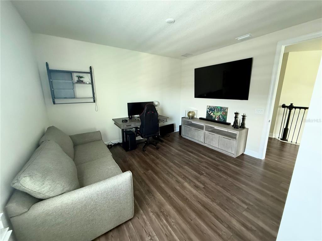 8441 Pk Clf Way Orlando, FL 32836 - Photo 28 of 59 a living room with furniture and a flat screen tv