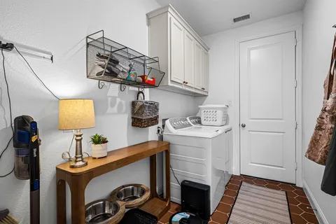 a bedroom with a bed and a computer on a desk