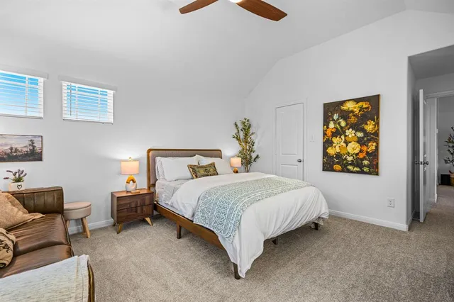 a bedroom with bed couch and window