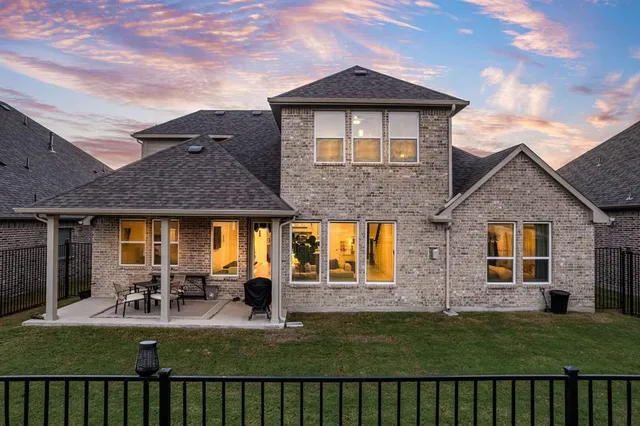 a view of a house with a big yard and large trees