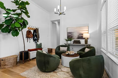 a living room with furniture potted plant and a window