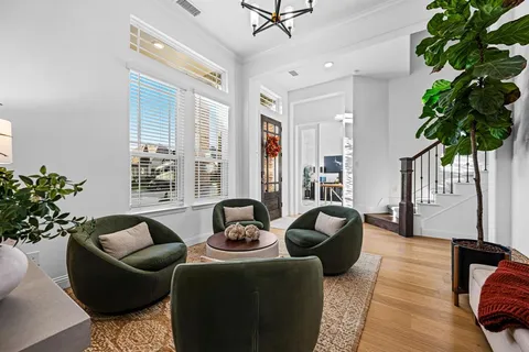 a living room with furniture potted plant and a window