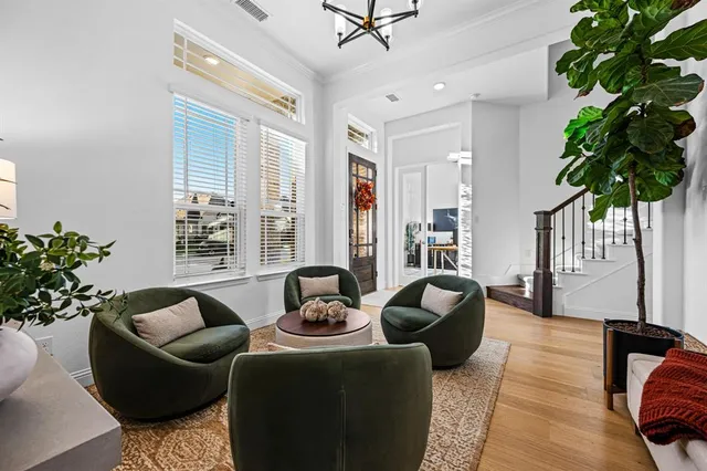 a living room with furniture potted plant and a window