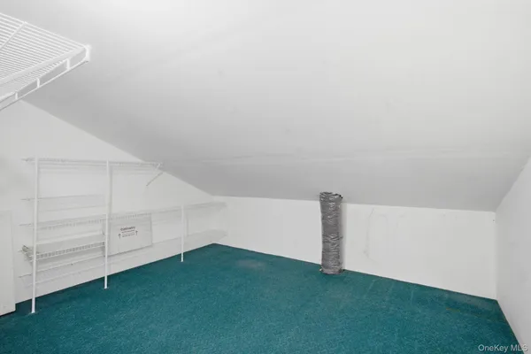 an empty room with windows and fireplace