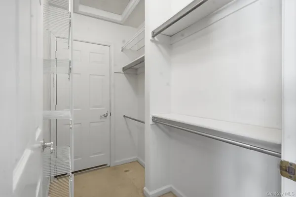 a view of a hallway view with wooden floor and a window