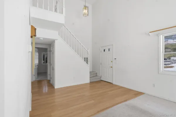 a view of entryway and hall with wooden floor