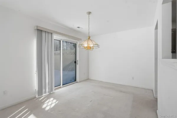 a view of a room with a ceiling fan