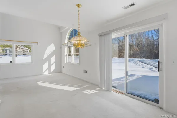 a view of empty room with floor to ceiling window