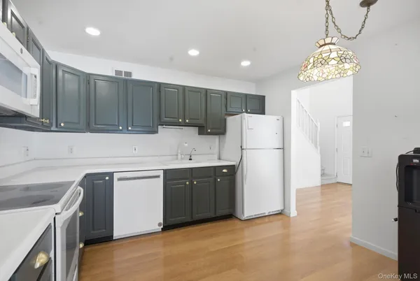 a kitchen with cabinets a refrigerator and a sink