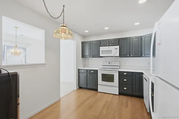 a kitchen with stainless steel appliances a stove a sink and a refrigerator