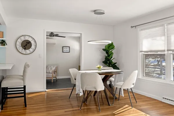 a view of a dining room with furniture window and wooden floor