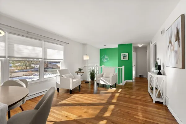 a living room with furniture a large window with wooden floor