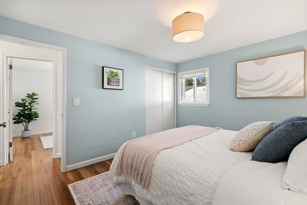 a bedroom with a bed and a painting on the wall