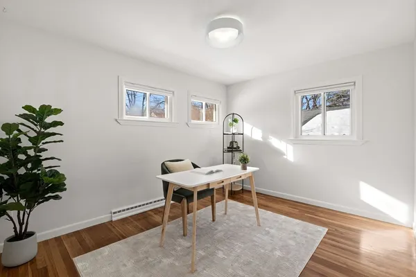 wooden floor in an empty room with a window