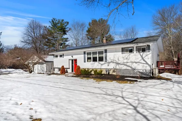 a view of a house with a snow in the yard and covered with snow