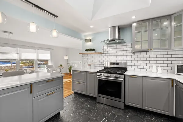 a kitchen with stainless steel appliances granite countertop a stove a sink and a granite counter tops