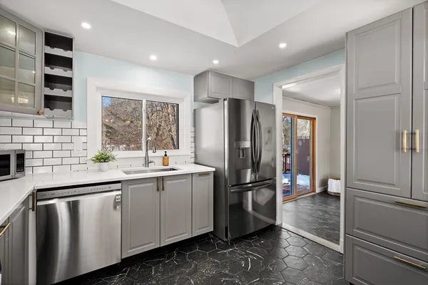 a kitchen with stainless steel appliances a refrigerator and a sink