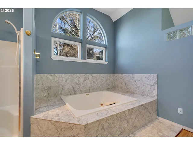 a bathroom with a granite countertop sink a vanity and a large mirror