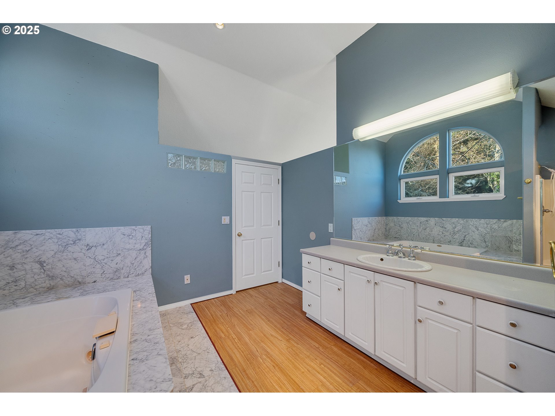4805 Leonard Street West Netarts, OR 97141 - Photo 18 of 34 a bathroom with a granite countertop sink a vanity and a large mirror