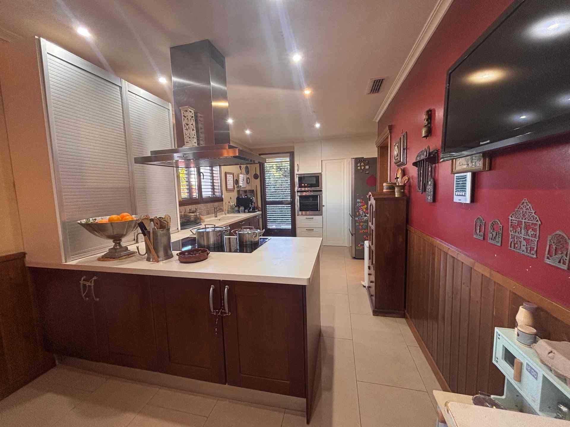 8 Carrer Del Teuladí Charlottesville, VC 46117 - Photo 25 of 30 a kitchen with kitchen island stainless steel appliances a sink a counter top space and cabinets