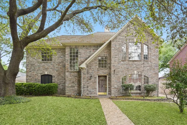a large brick building with a yard in front of the house