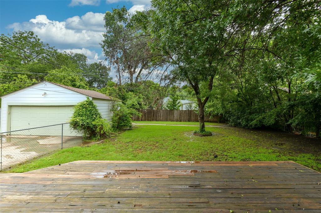 3516 Rashti Court Fort Worth, TX 76109 - Photo 20 of 24 View of yard with an outbuilding, a garage, and a deck