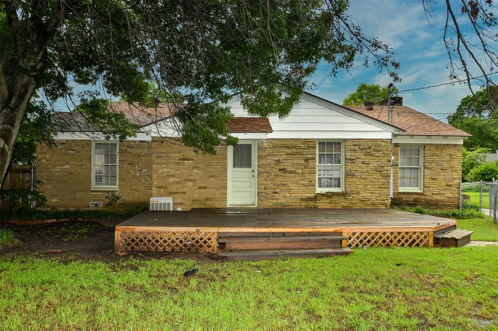 3516 Rashti Court Fort Worth, TX 76109 - Photo 22 of 24 Back of property featuring central air condition unit, a wooden deck, and a yard