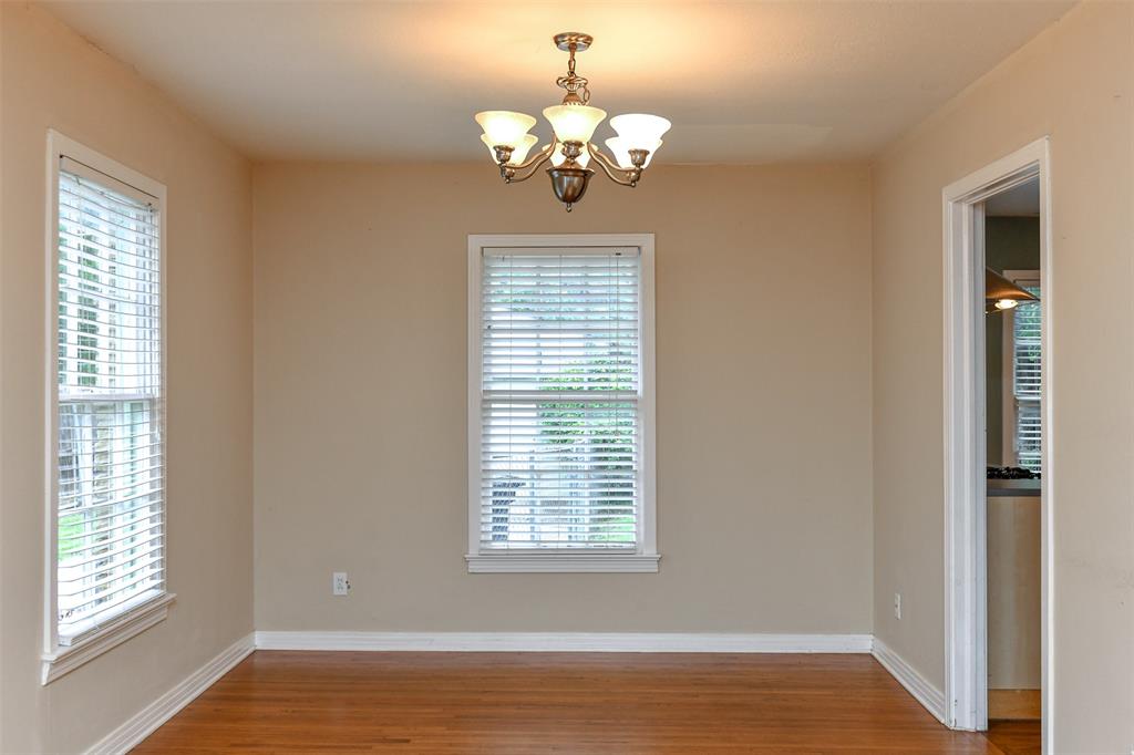 3516 Rashti Court Fort Worth, TX 76109 - Photo 6 of 24 Spare room featuring wood-type flooring and an inviting chandelier
