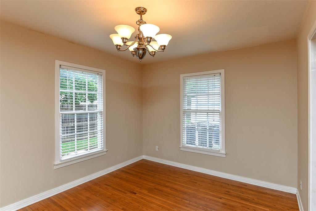 3516 Rashti Court Fort Worth, TX 76109 - Photo 7 of 24 Spare room with wood-type flooring and a chandelier