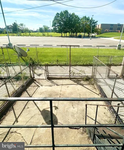 a view of a patio with table and chairs with wooden floor and fence