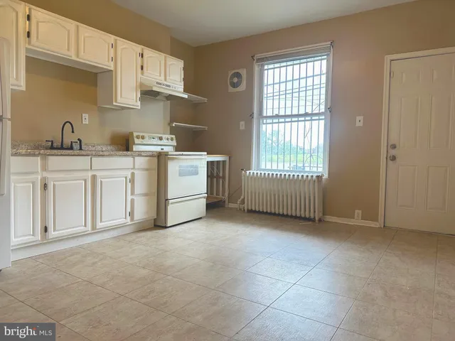 a view of kitchen with granite countertop cabinets