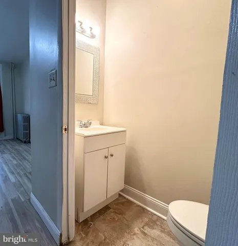 a bathroom with a sink a toilet and a mirror