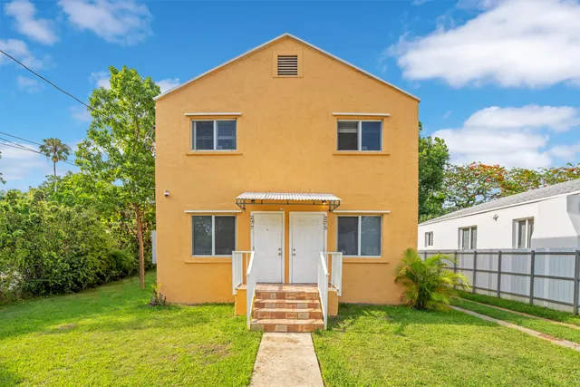 a front view of a house with garden