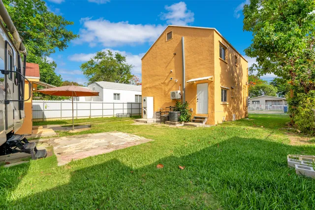 a bedroom with a bed and a window with couch