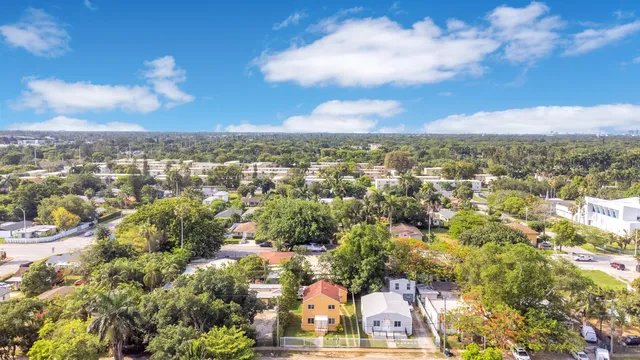 an aerial view of residential houses with city view