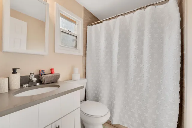 a view of a balcony with wooden floor and fence