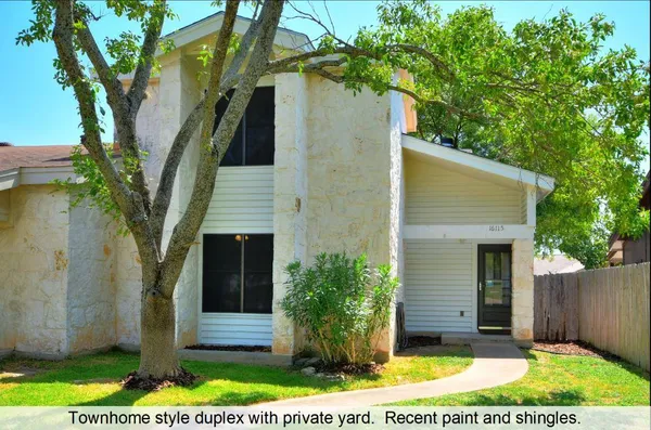a view of a house with a tree