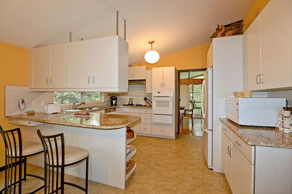 4 Holiday Road Wayland, MA 01778 - Photo 11 of 25 a kitchen with a sink appliances and cabinets