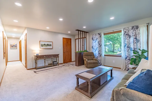a living room with furniture a window and a fireplace