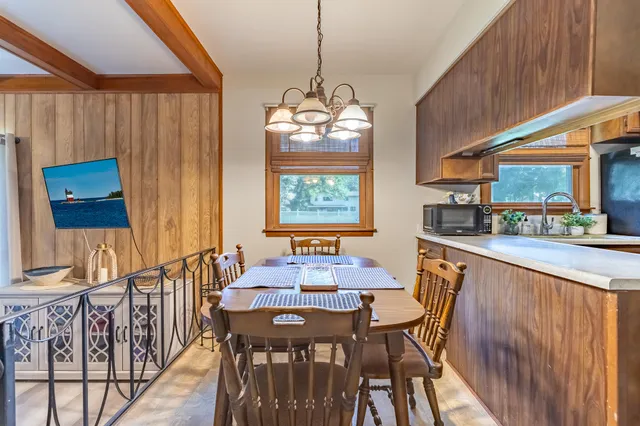 a dining room with furniture a window and wooden floor