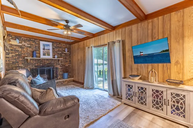 a living room with furniture a fireplace and a window