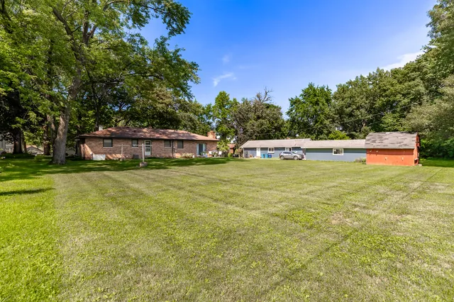 a view of outdoor space with swimming pool and trees in the background