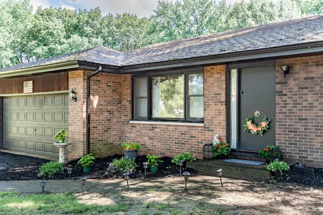 a front view of a house with garden