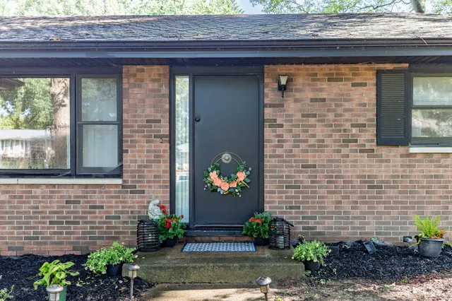 a front view of a house with a garden