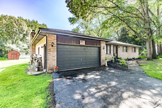 a view of house with backyard and garden