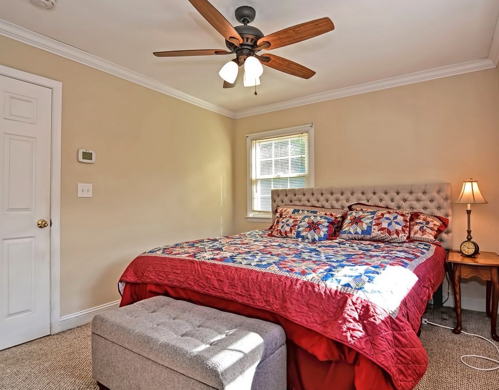 88 Rice Corner Road Brookfield, MA 01506 - Photo 29 of 39 a bedroom with a bed and a chandelier
