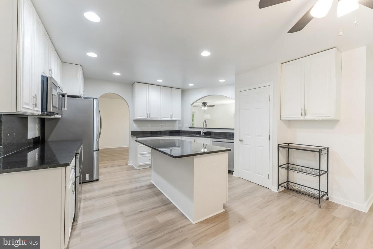 11621 Sourwood Lane Reston, VA 20191 - Photo 19 of 26 a kitchen with stainless steel appliances granite countertop a sink a stove and a refrigerator